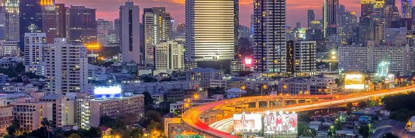 Landscape building modern business district of Bangkok. Expressway in the foreground at twilight.